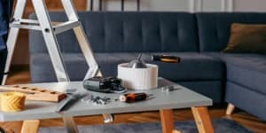 Essential tools and materials laid out for a ceiling fan installation.